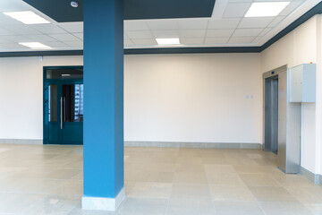 An empty space with railings and large windows. The modern interior of the lobby of the office building. A lighted long corridor in a modern business center