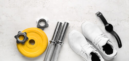 Barbell plates, shoes, watches, grips and clamps on white background