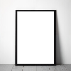 Vertical empty poster within a frame, leaning against a white wall on a wooden floor. Mockup.