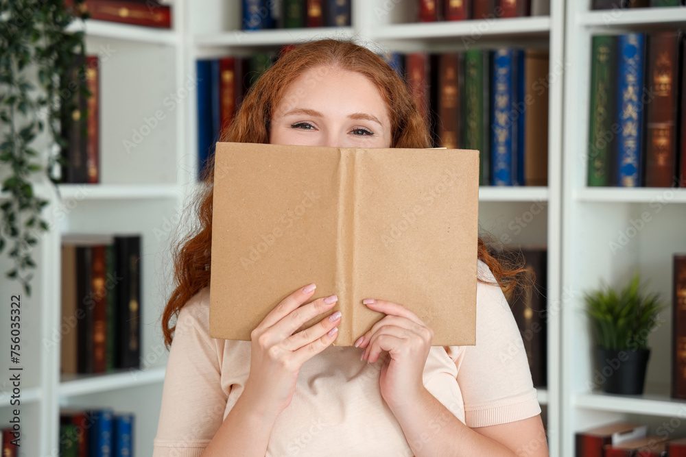 Poster young woman reading book in library