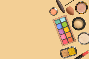 Different decorative cosmetics on yellow background