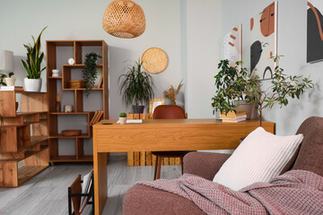 Interior of living room with green plants and workplace