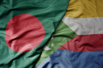 big waving national colorful flag of comoros and national flag of bangladesh.