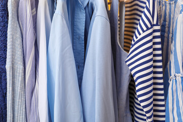 Stylish clothes hanging on rack, closeup