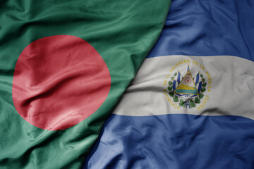 big waving national colorful flag of el salvador and national flag of bangladesh.