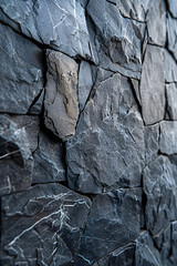 A closeup of a stone wall made of grey bedrock with a mixture of rocks showing a intricate pattern and formation. It includes wood intrusions and hints of fault lines in the rock outcrop