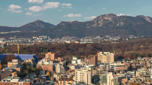 Seoul South Korea time lapse city skyline at Seoul city center view from Naksan Park in autumn