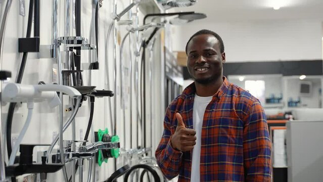 Portrait of salesman near bathroom shower mixer in a plumbing shop