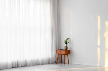 Interior of room with light curtain and table