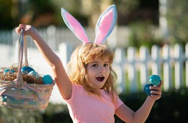 Excited child with easter basket. Child boy hunting easter eggs. Kid with easter eggs and bunny...