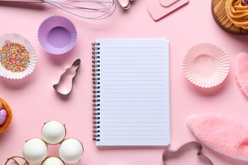 Blank notepad for recipes with Easter bunny ears, eggs and baking tools on pink background