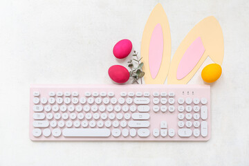 Composition with modern keyboard, Easter eggs and paper bunny ears on light background