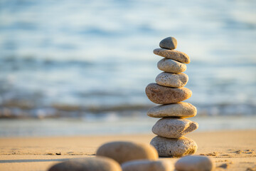 Fototapeta na wymiar Pebble tower balance harmony stones over the beach
