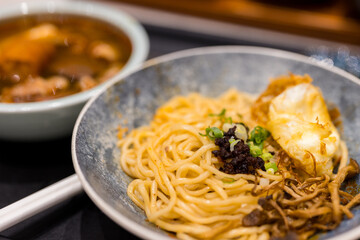 Spicy noodles with fried egg and mushroom