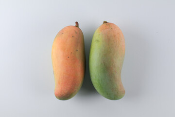 Yellow Mango on white background. Sweet dessert or vegetarian food. Organic product. Raw juicy fruit