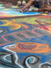 Sidewalk is covered with chalk drawings at chalk art festival