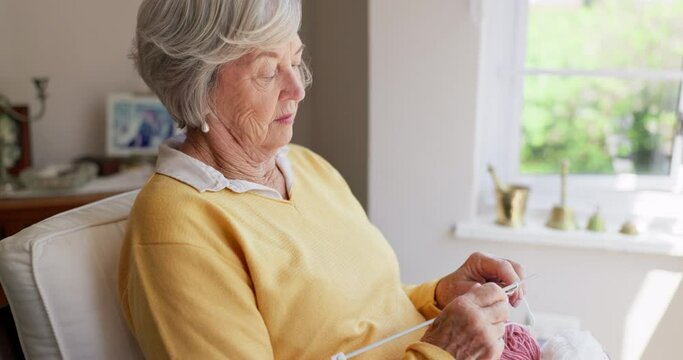 Elderly, woman and knitting thread with needle for relaxing creativity in retirement for handmade, crochet or hobby. Old person, hands and loop yarn in apartment for sweater pattern, skill or cotton