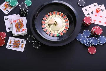 Foto op Plexiglas Roulette wheel, playing cards and chips on table, flat lay. Casino game © New Africa