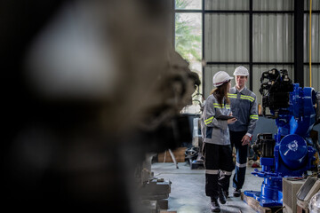 engineers check control heavy machine robot arm. Diverse Team of Industrial Robotics Engineers Gathered Around Machine. Professional Machinery Operators repair electric robot on bright digital panel.