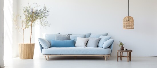 Blue sofa and wicker rug in minimalistic white living space