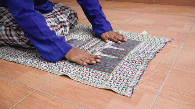 Muslim religious asian man pray to God in sujood position, for praise and glorify Allah. Muslim people praying concept.
