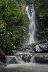 Famous scenic Yeh Mampeh waterfall flowing in the tropical forest of Buleleng province, Bali island, Indoneisa