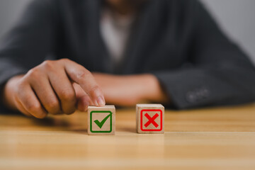 Businessman is thinking and making choices right from wrong symbols. Decide to vote accept or not....