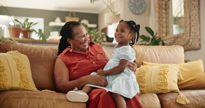 Grandmother, child and hug or communication in home, affection and bonding or care in living room. Black family, grandkid and grandma on couch and happy on weekend, conversation and embrace in lounge