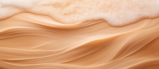A close up of a rich and creamy substance topped with frothy foam, resembling a natural landscape with soft peach hues, like petals on hardwood, contrasting against the rocky formation of the soil