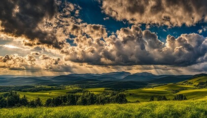 Fototapeta premium Radiant Sunbeams Over Rolling Hills