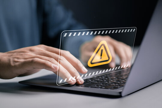 System hacked warning alert. Person use laptop with warning sign for cyber attack. Ransomware, Virus, Spyware, Malware or Malicious software, Data breach, Cyber security and cybercrime.