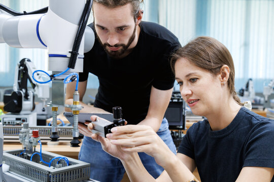 automation machine engineer students study and inspection control robot arm machine in robotics engineering academy at university or factory workshop. AI robot technology, future innovation trend.