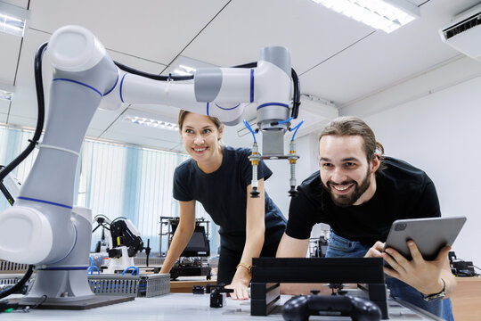 automation machine engineer students study and inspection control robot arm machine in robotics engineering academy at university or factory workshop. AI robot technology, future innovation trend.