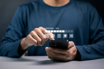 Software update or operating system upgrade. Improved functionality in the new version and improved security. Businessman use smartphone with updating bar on virtual screen.