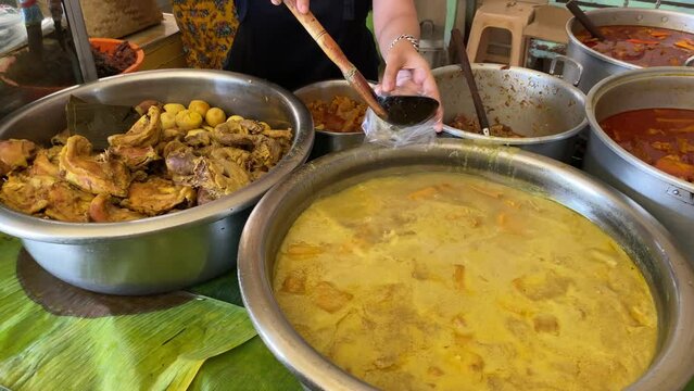 Seller preparing opor tumpang koyor Indonesian food from Salatiga