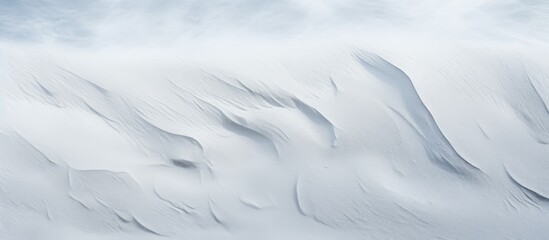 A closeup of a snowy slope with a blurred background, showcasing the freezing polar ice cap landscape beneath a cloudfilled sky