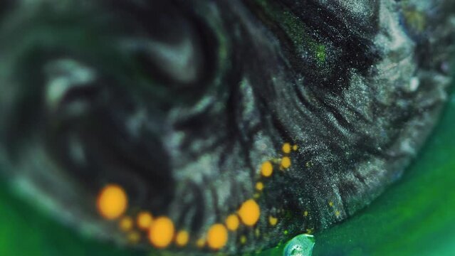 Paint blend background. Abstract ink design. Fantasy liquid. Shimmering black grey oil round spill with yellow drop motion on vivid green sparkling substance.