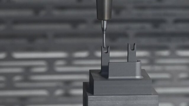 Pan scene the CNC milling machine cutting the graphite electrode parts.