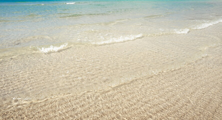 Fototapeta na wymiar Clear water at the beach on a tropical island,Crystal clear turquoise water under a blue sky