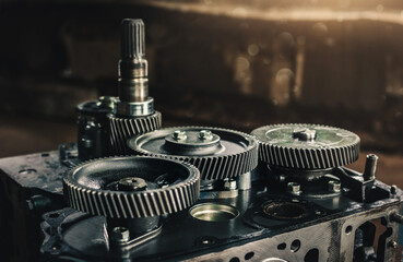 Engine cylinder head lying on a table in a car service. Maintenance the engine and replace engine...