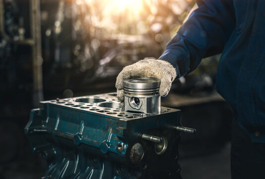 Car spare parts.The cylinder head of an internal combustion engine. Close-up of the mechanic's hands. Product control. Installation of condensers. Preparation for installation. Repair and maintenance.