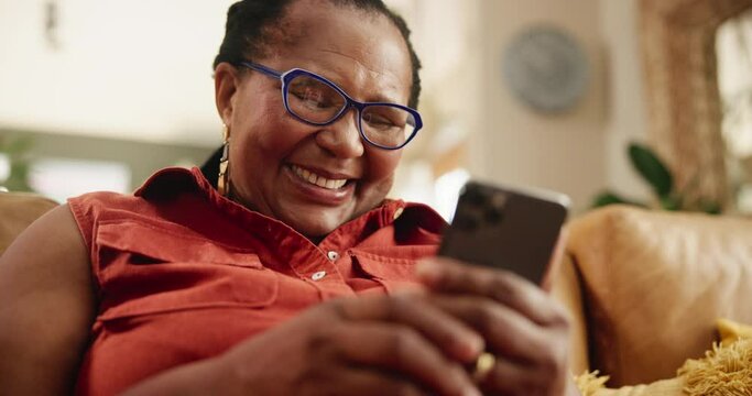 Cellphone, laughing and senior woman on sofa reading funny, comic or comedy online blog on website. Happy, relax and mature African female person scroll on article website with phone in living room.