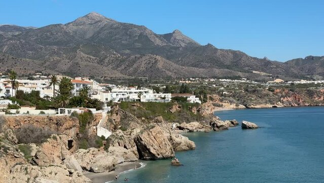 Slow pan of the pretty seaside town of Nerja Spain