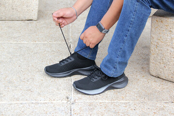 Latin adult man wears black tennis shoes that serve to protect the foot from friction with a...