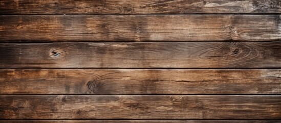 Fototapeta premium A close up of a rectangular brown hardwood table with a wood stain pattern, set against a blurred background of brickwork and metal accents