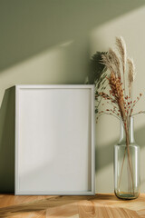 blank canvas frame template with dry flowers in vase on olive green wall mockup
