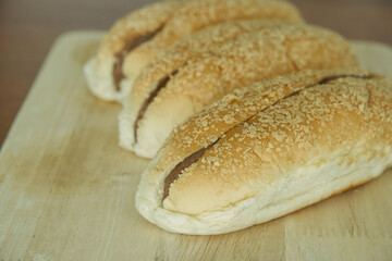 Chocolate bread bun on a wooden board.