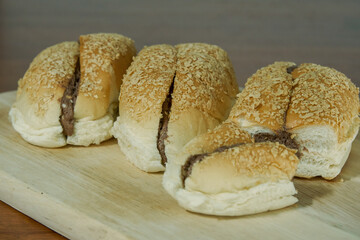 Chocolate bread bun on a wooden board.