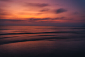Fototapeta na wymiar Sunset on the beach Beautiful colors of the sky and sea