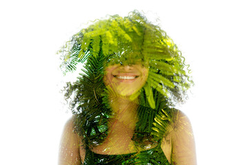 A double exposure portrait of a smiling woman merged with green fern - 756161585